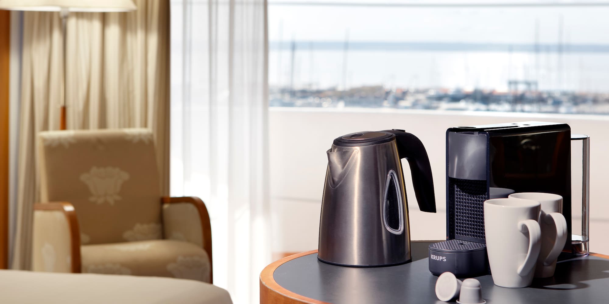 a coffee maker and cups on a table
