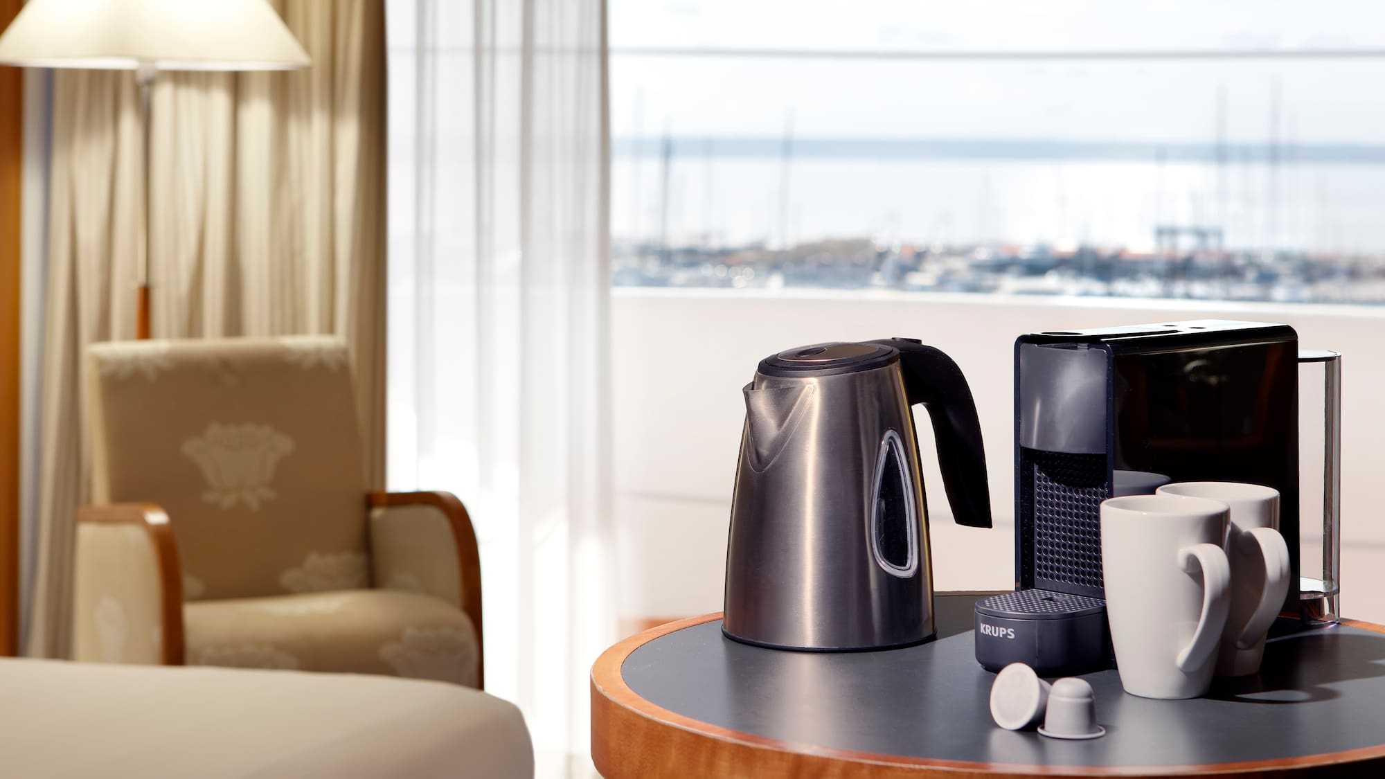 a coffee maker and cups on a table