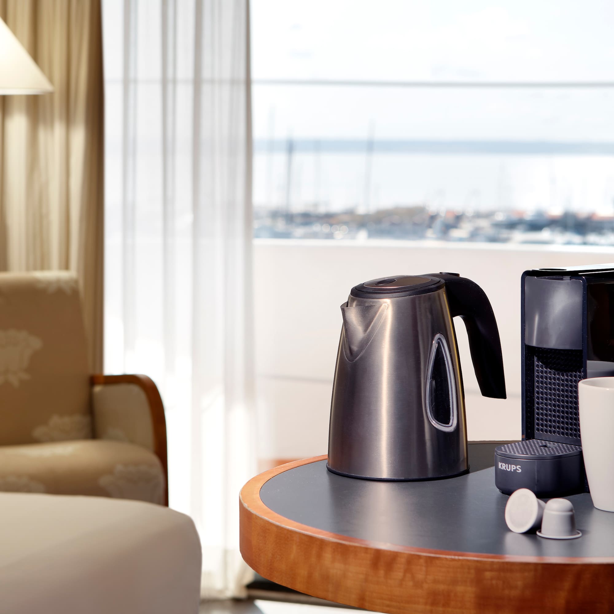a coffee maker and cups on a table