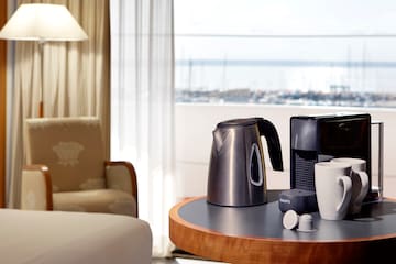 a coffee maker and cups on a table