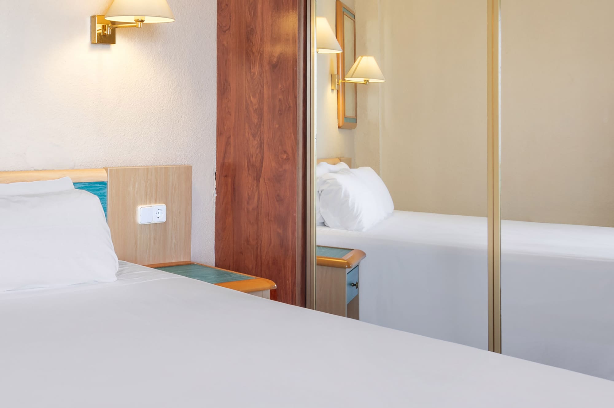 a room with a mirror and a bed