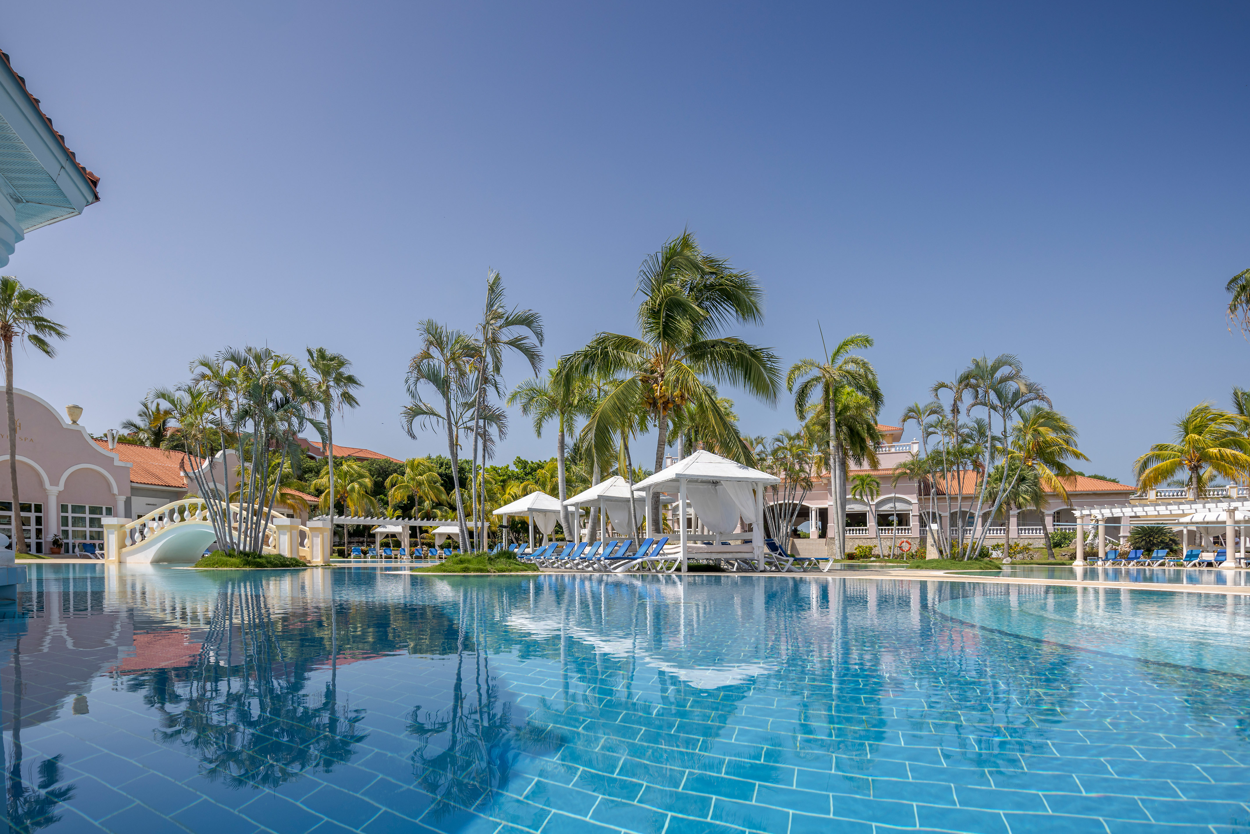 a pool with lounge chairs and umbrellas