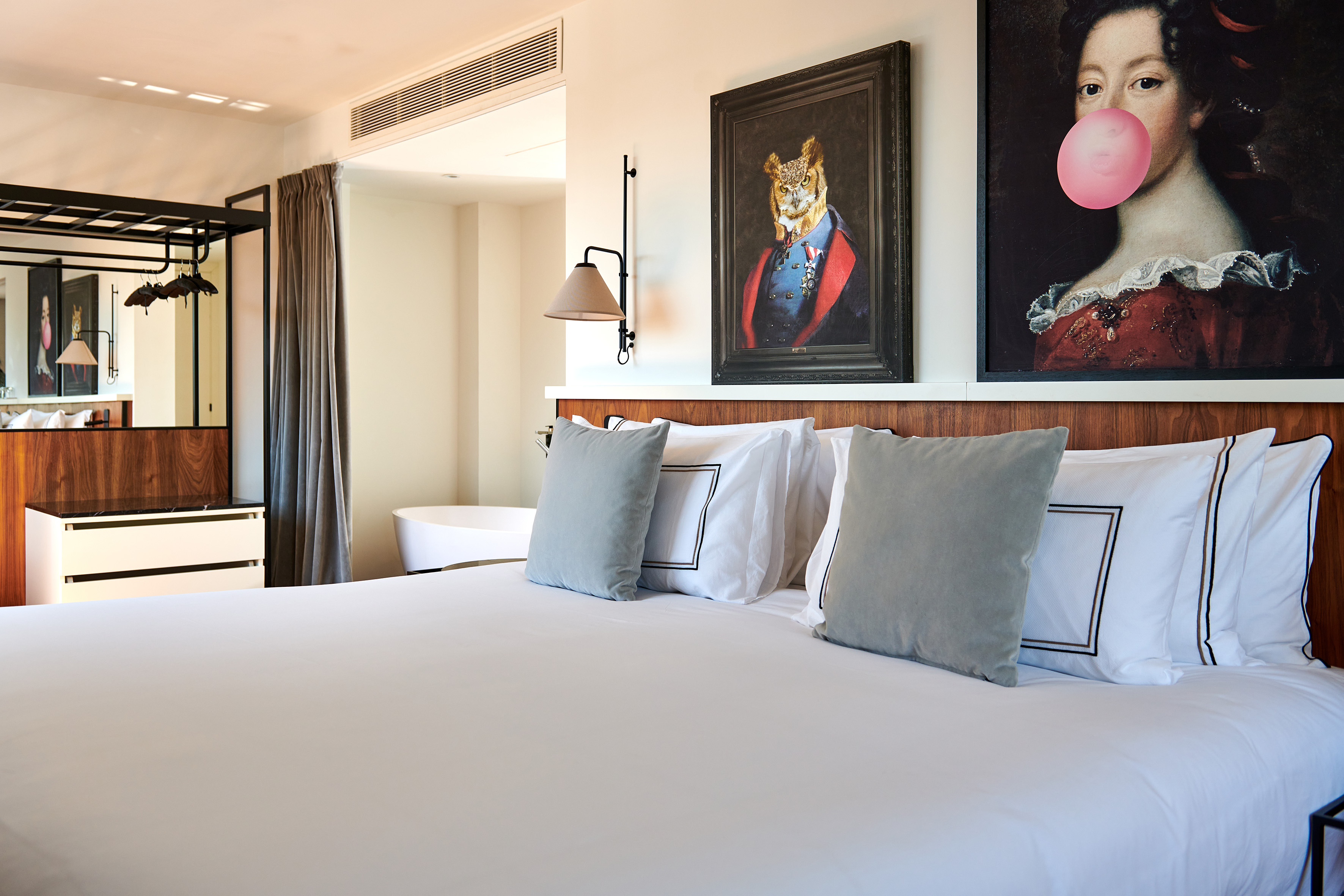 a bed with pillows and a painting of a tiger