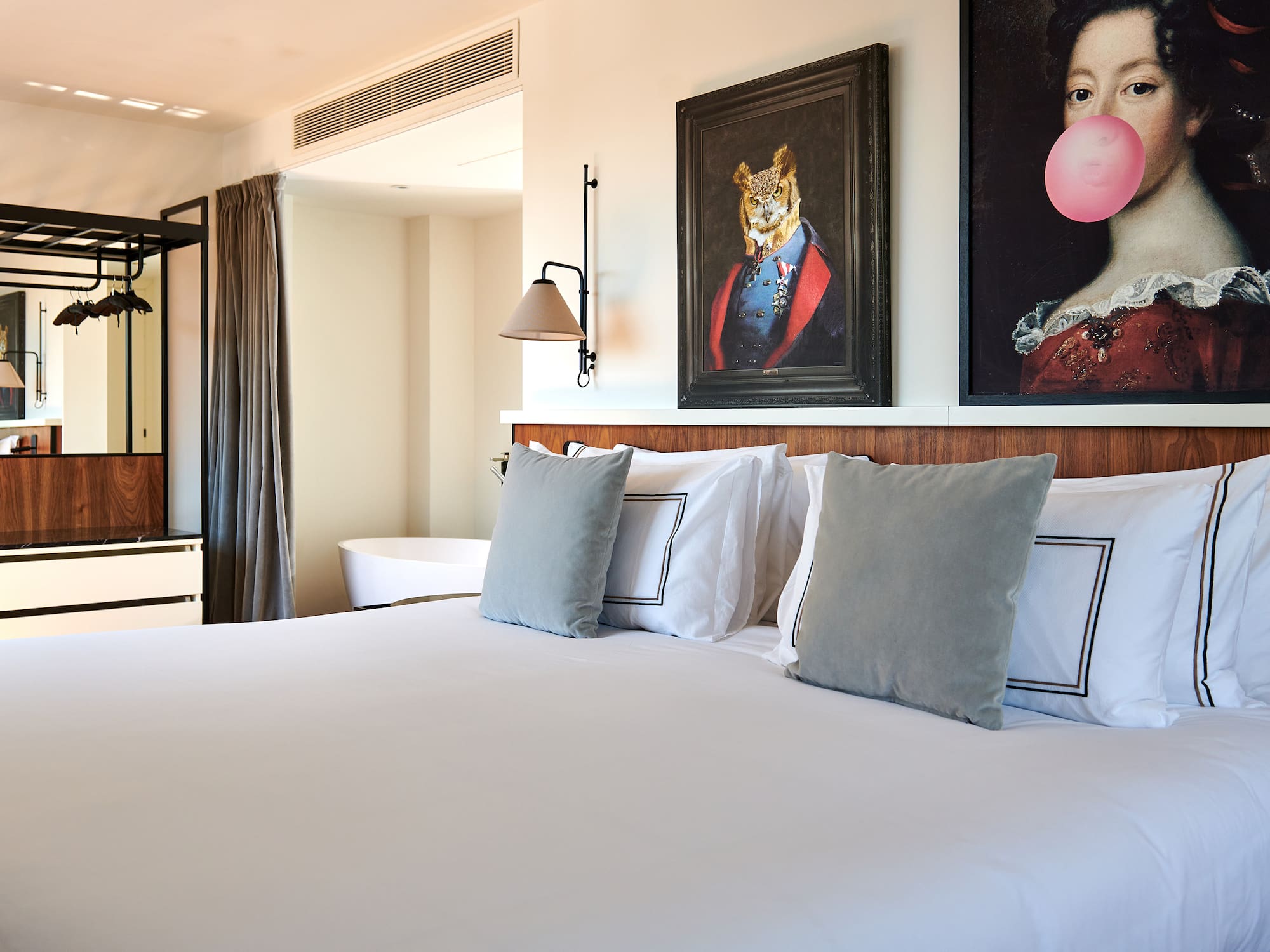 a bed with pillows and a painting of a tiger