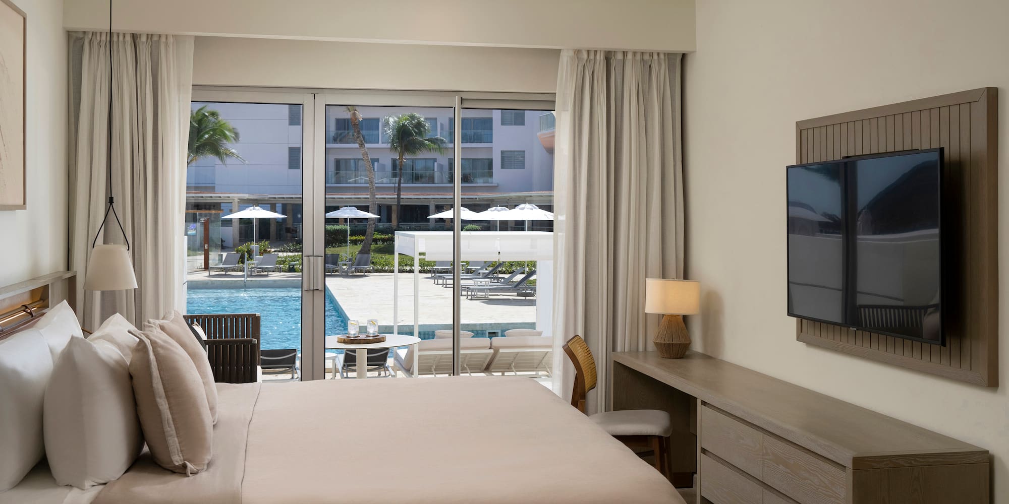 a bedroom with a television and a pool