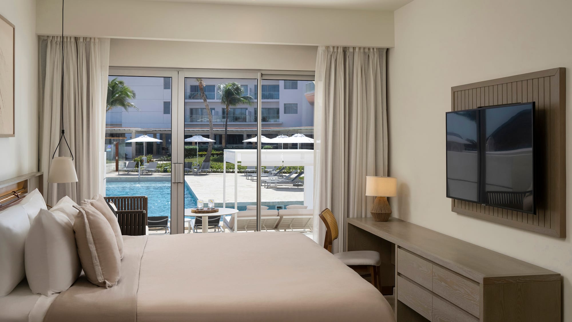 a bedroom with a television and a pool