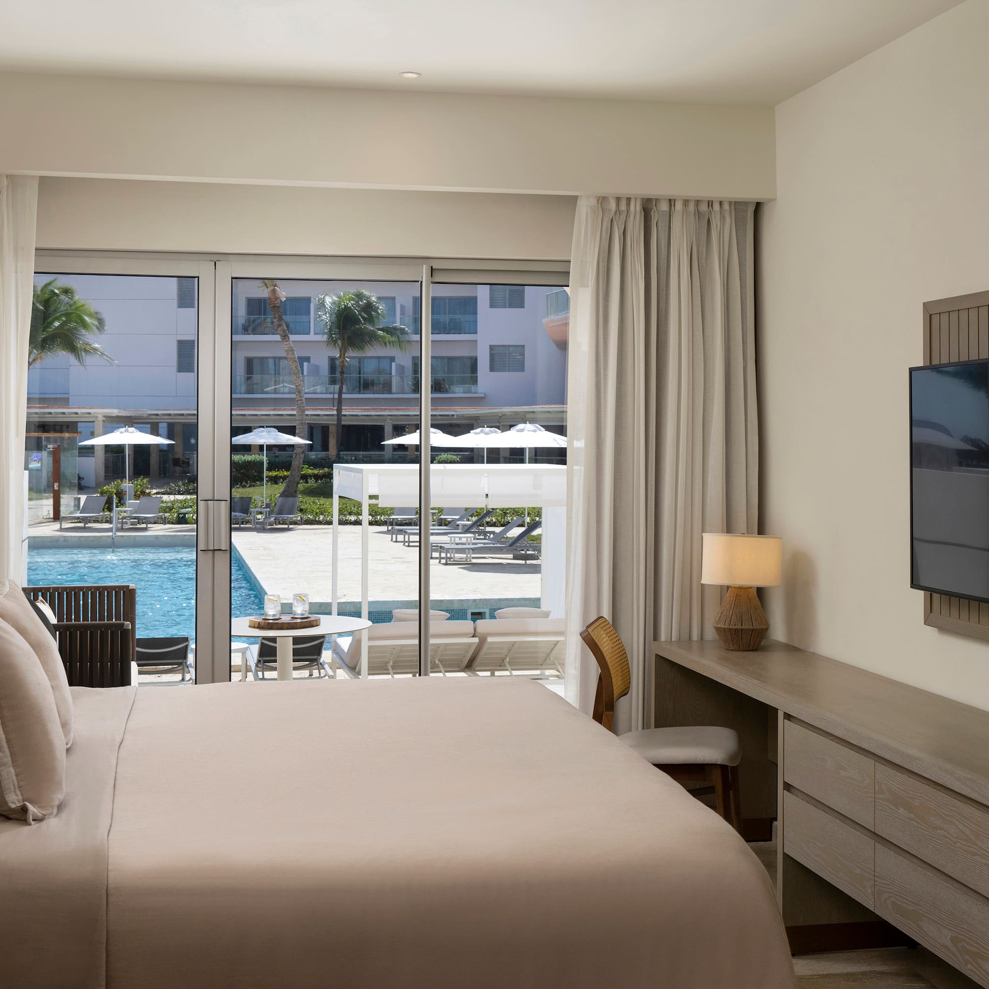 a bedroom with a television and a pool