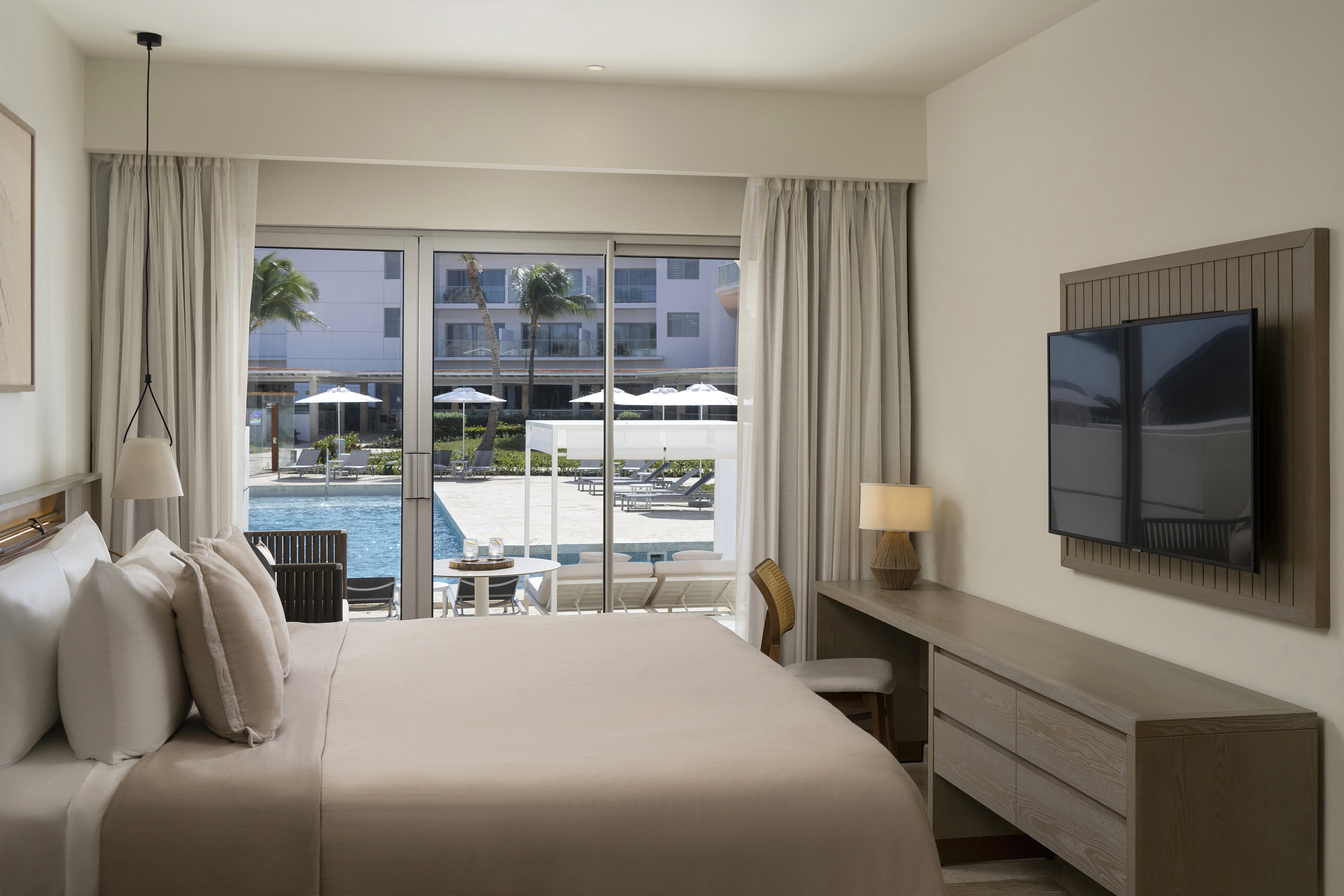 a bedroom with a television and a pool
