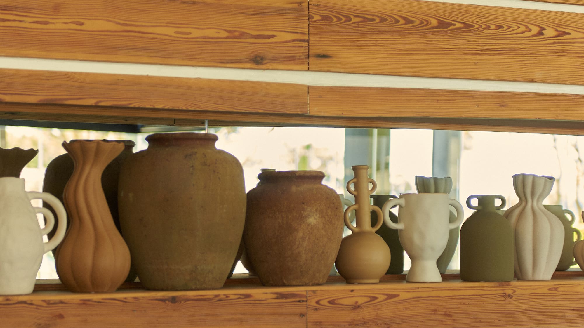 a group of vases on a shelf