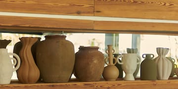 a group of vases on a shelf