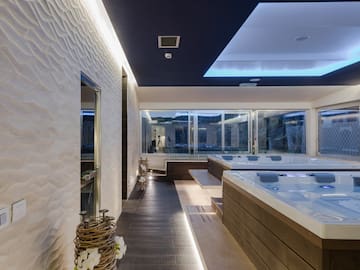 a room with a large tub and a large window