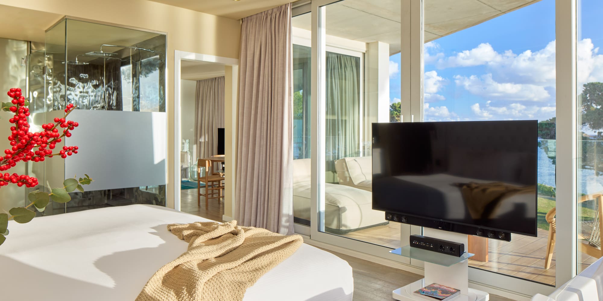 a bedroom with a television and a large window