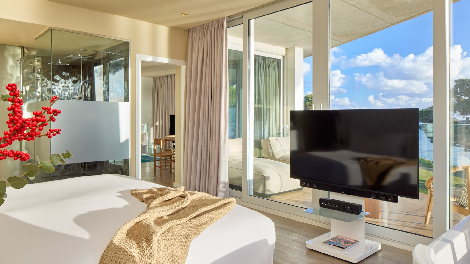 a bedroom with a television and a large window