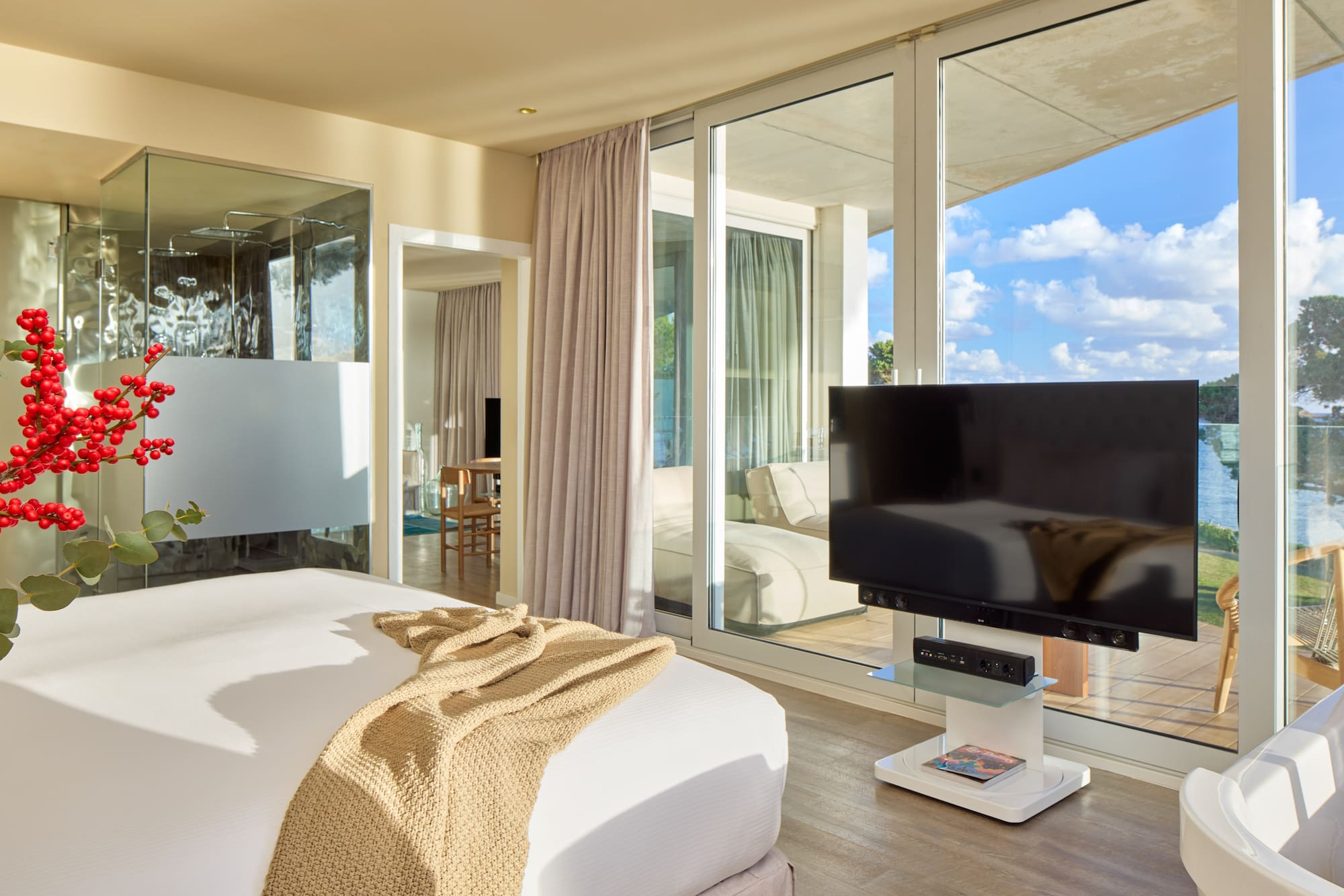 a bedroom with a television and a large window