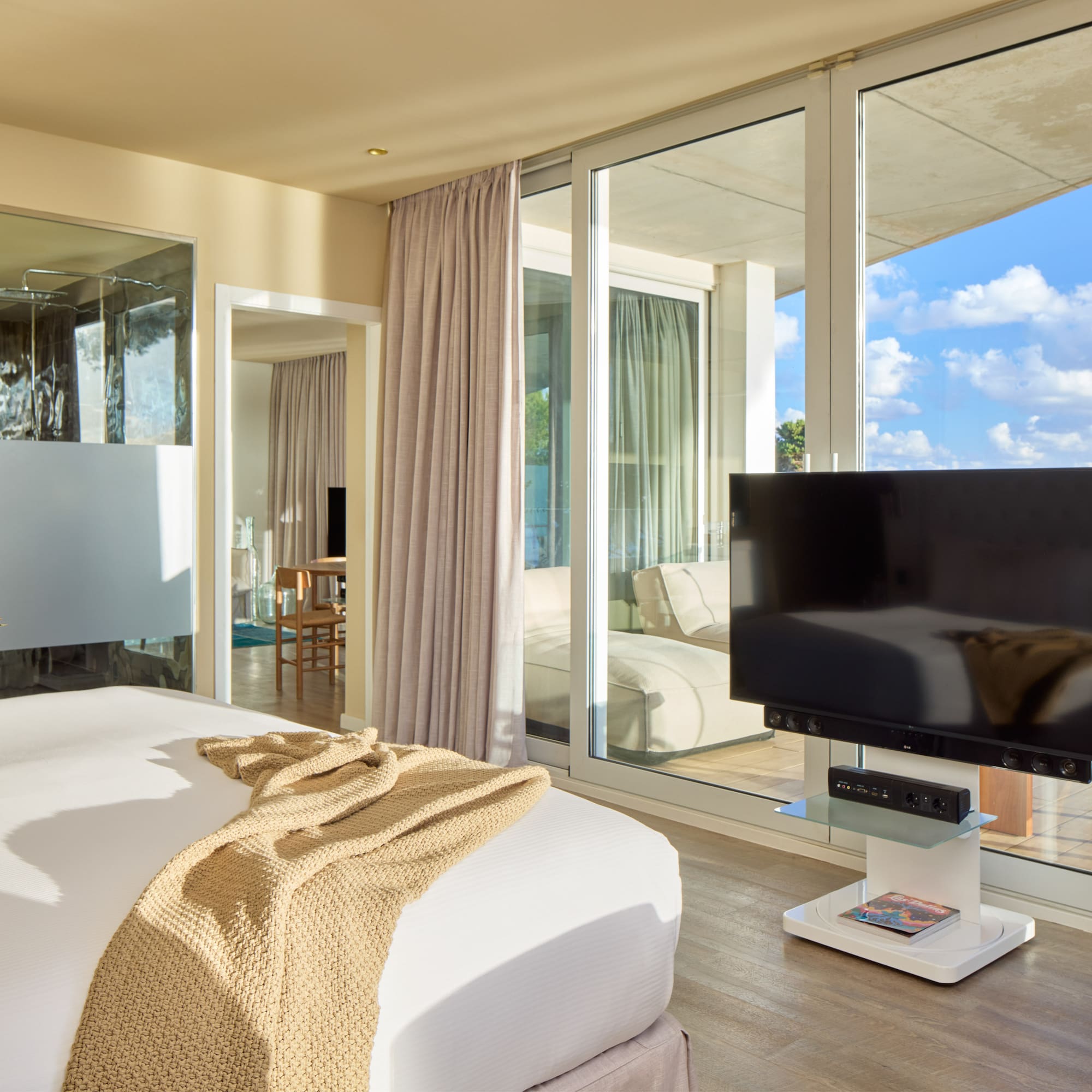 a bedroom with a television and a large window