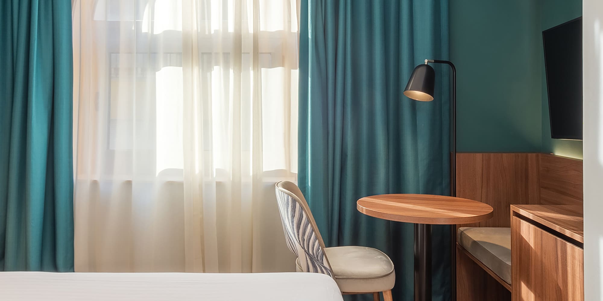 a room with a bed and a table and chair