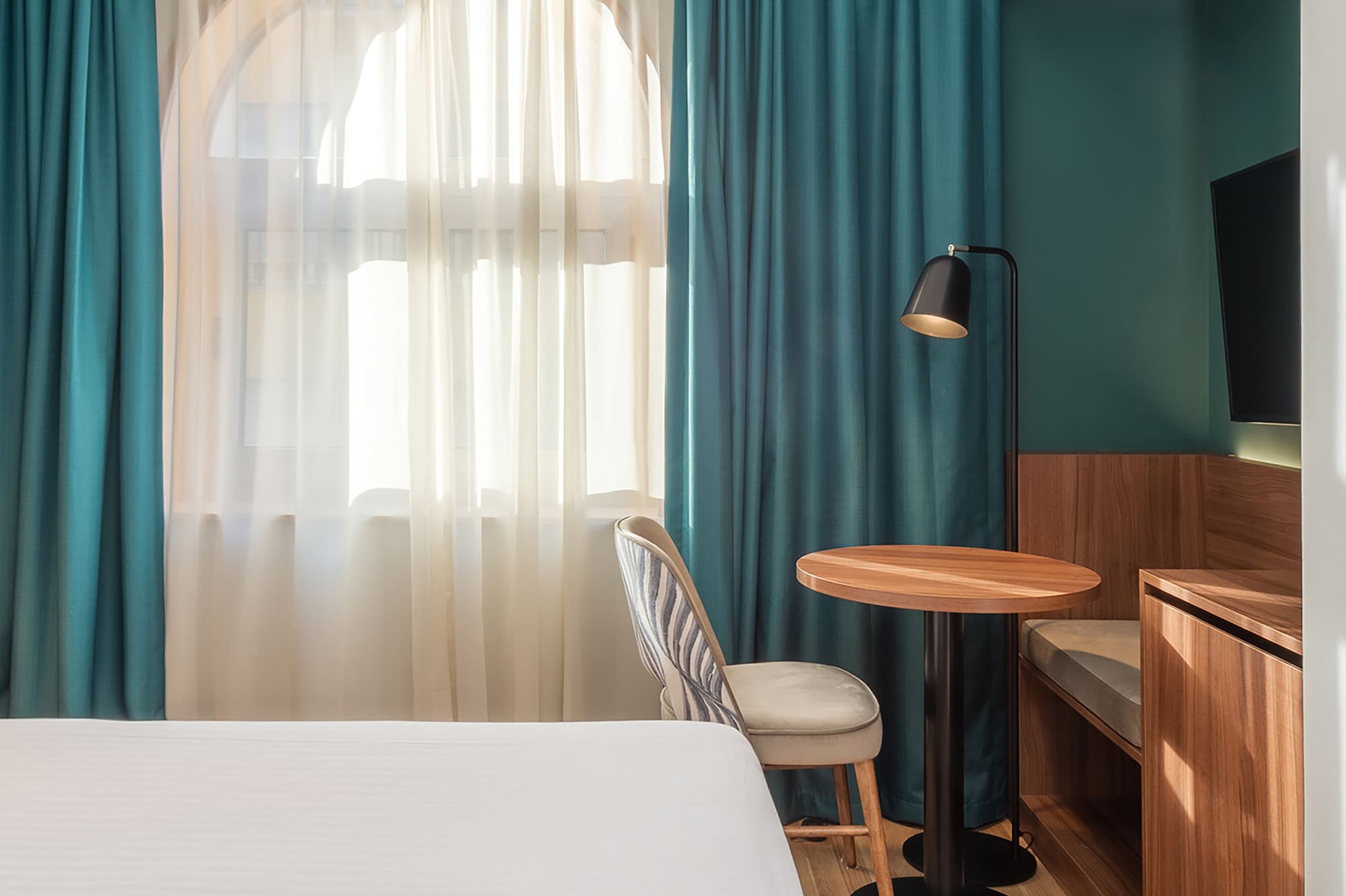 a room with a bed and a table and chair