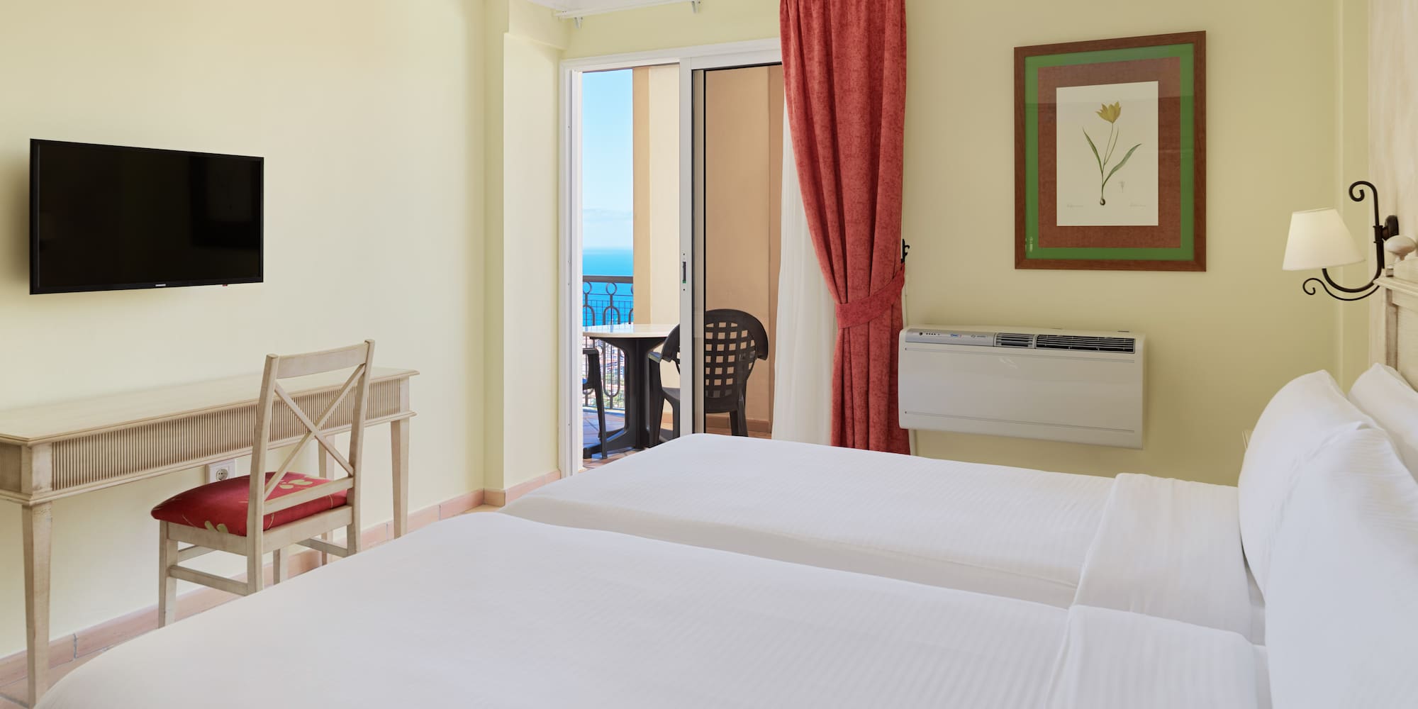 a room with two beds and a television