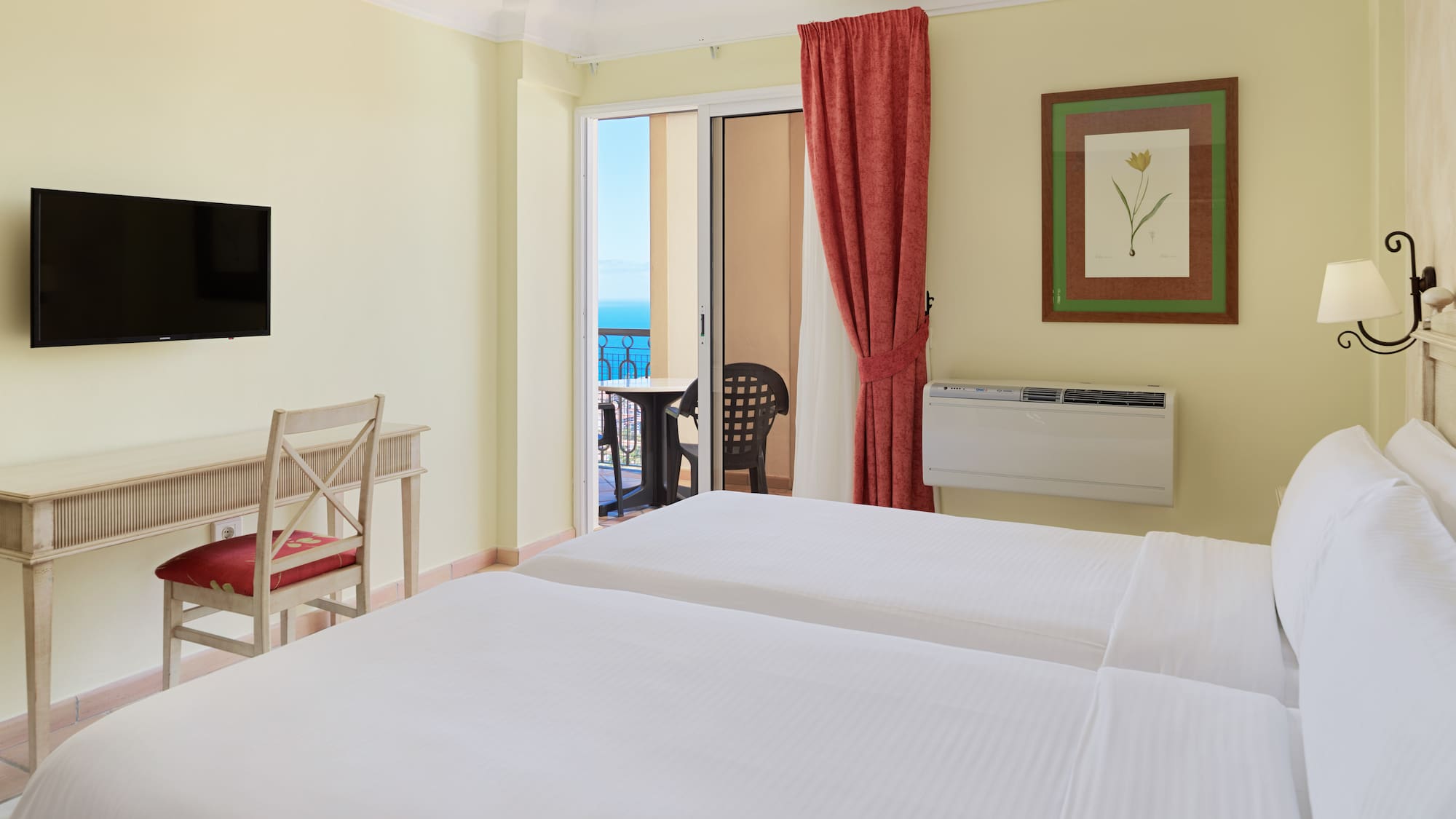 a room with two beds and a television