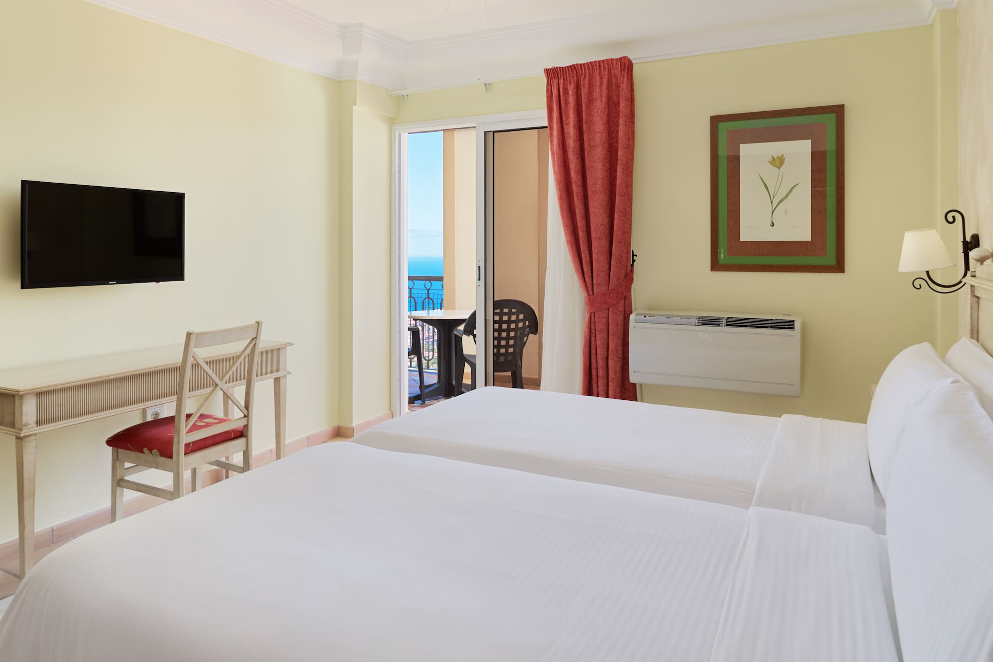 a room with two beds and a television