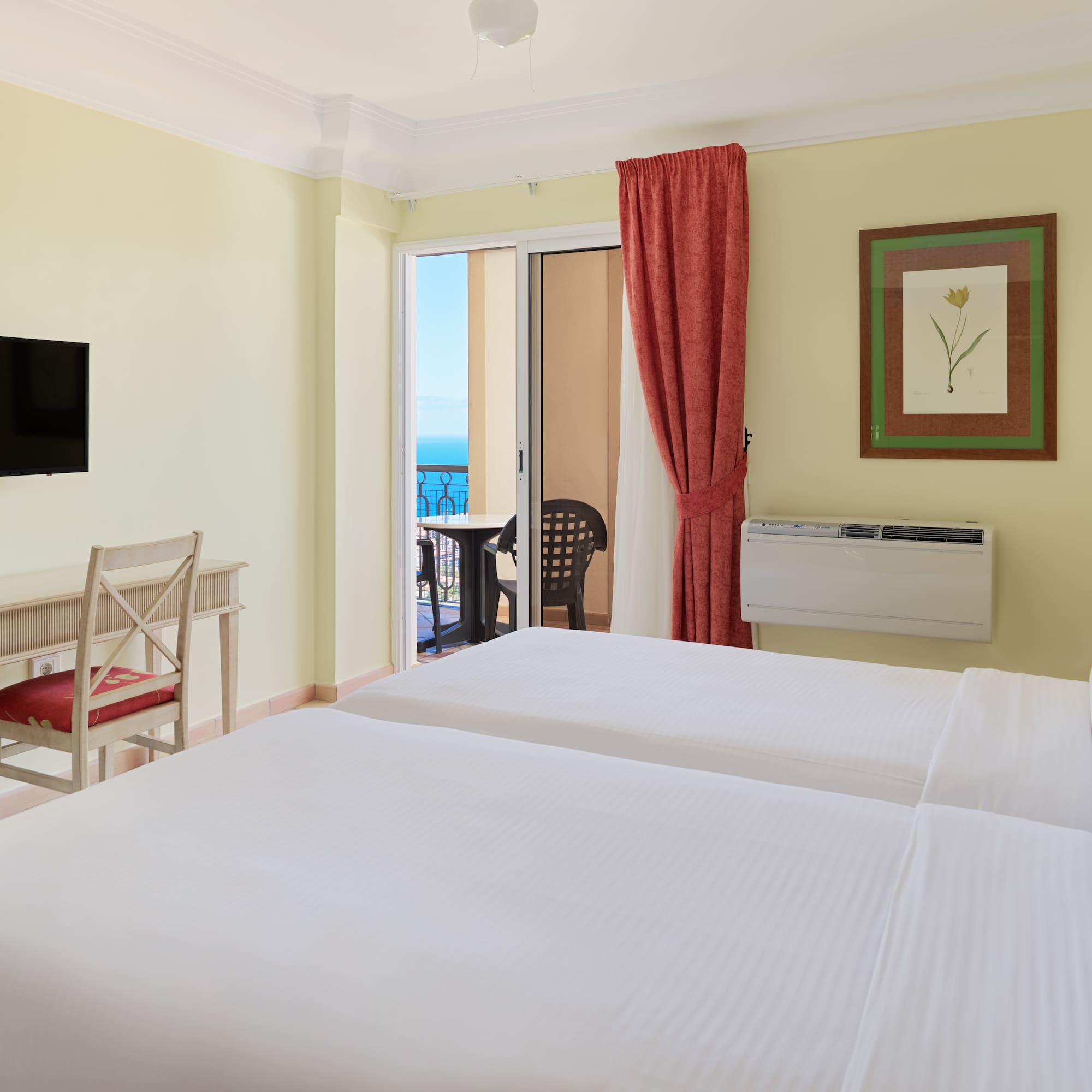 a room with two beds and a television