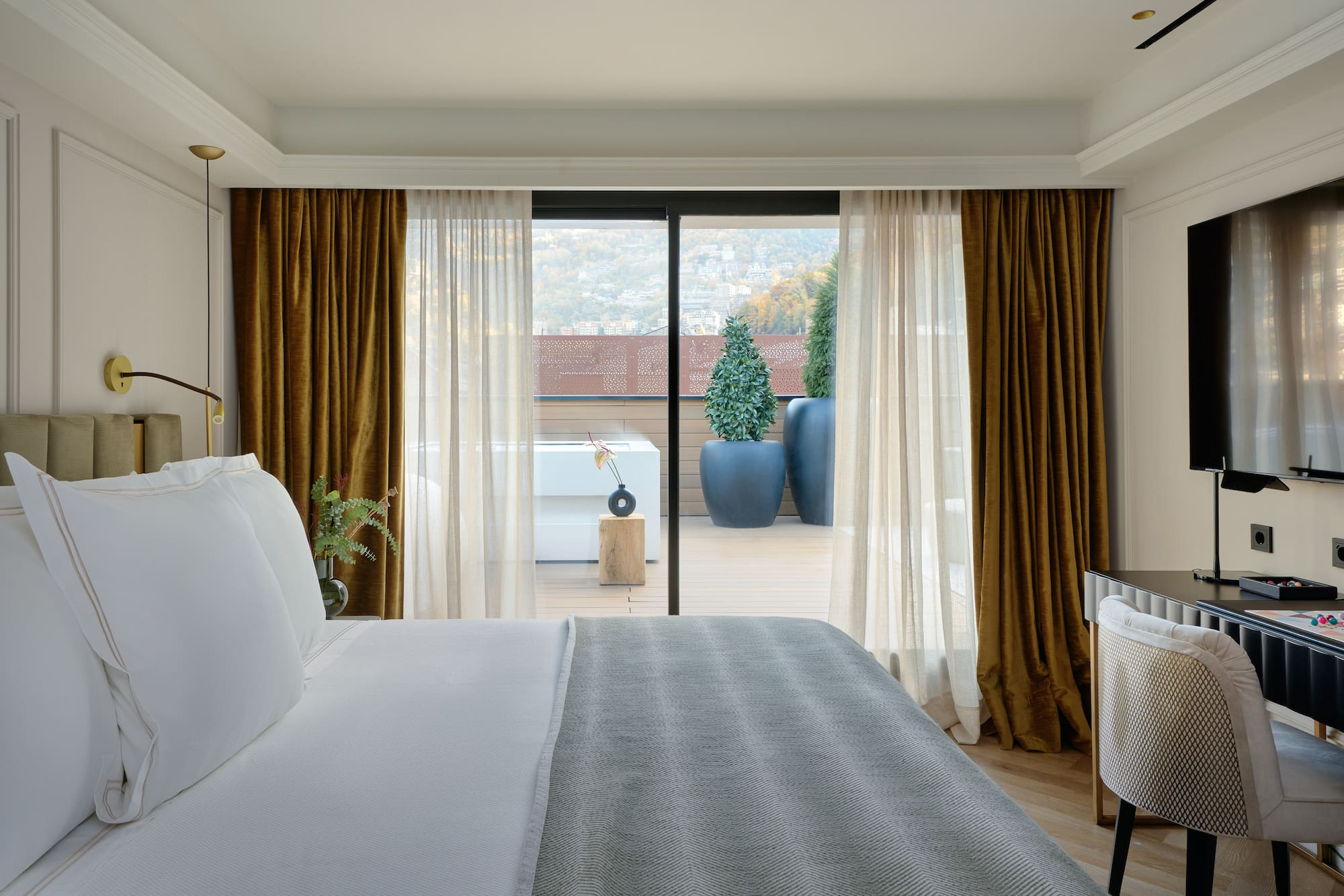 a bed with a glass door leading to a balcony