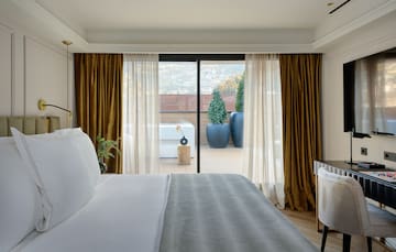 a bed with a glass door leading to a balcony