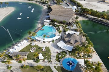 a resort with a pool and a body of water