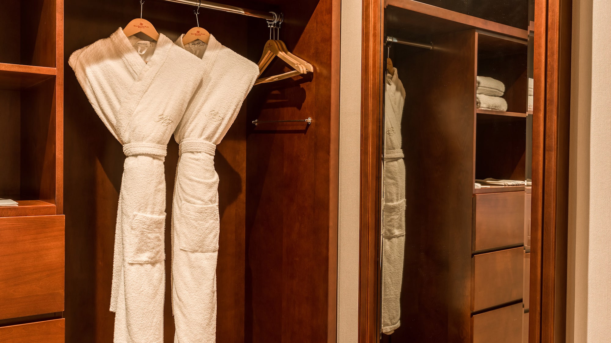 a closet with white robes in it