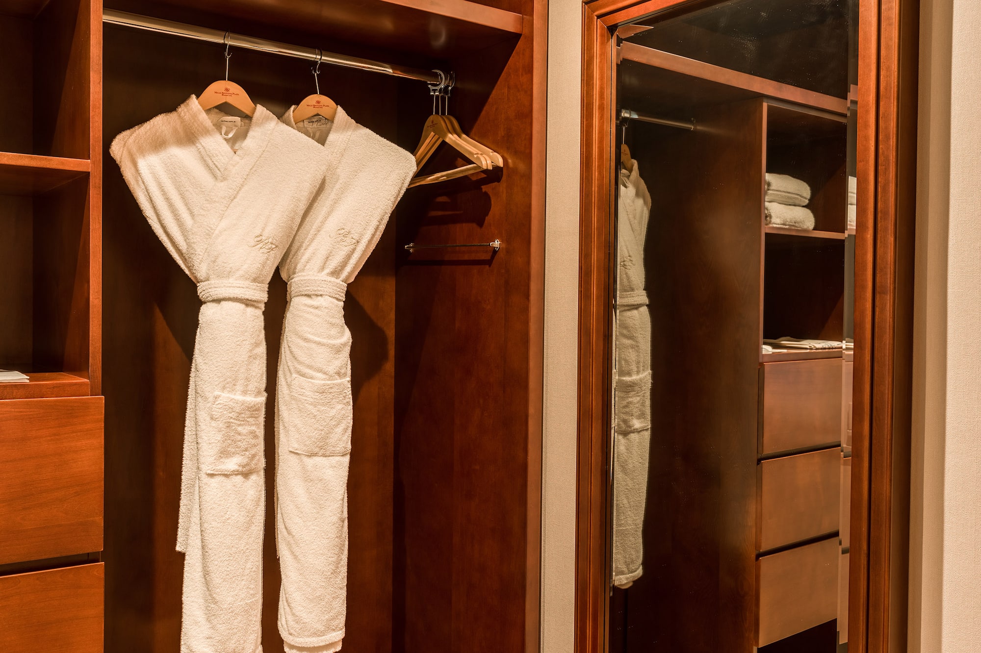 a closet with white robes in it