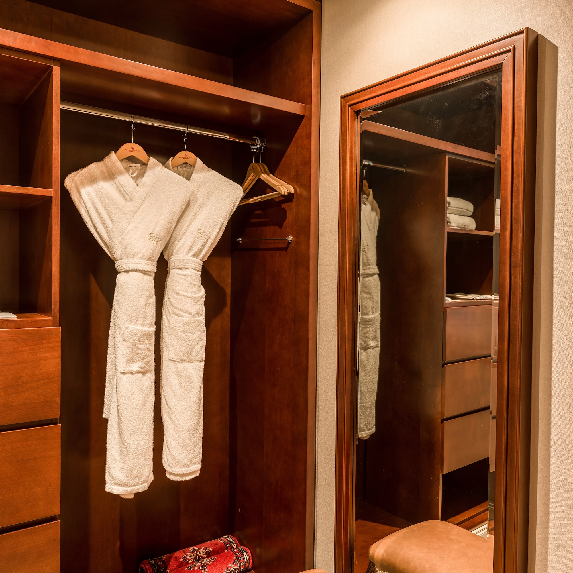 a closet with white robes in it