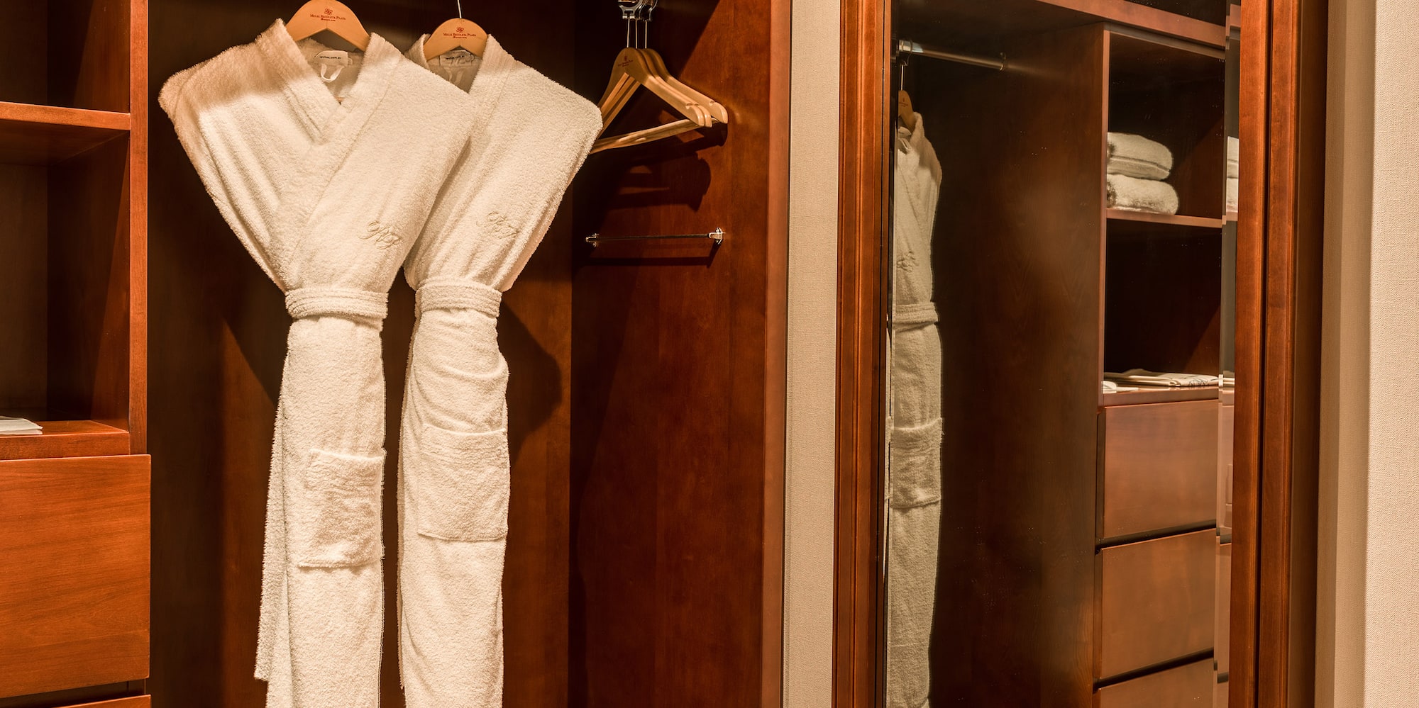 a closet with white robes in it