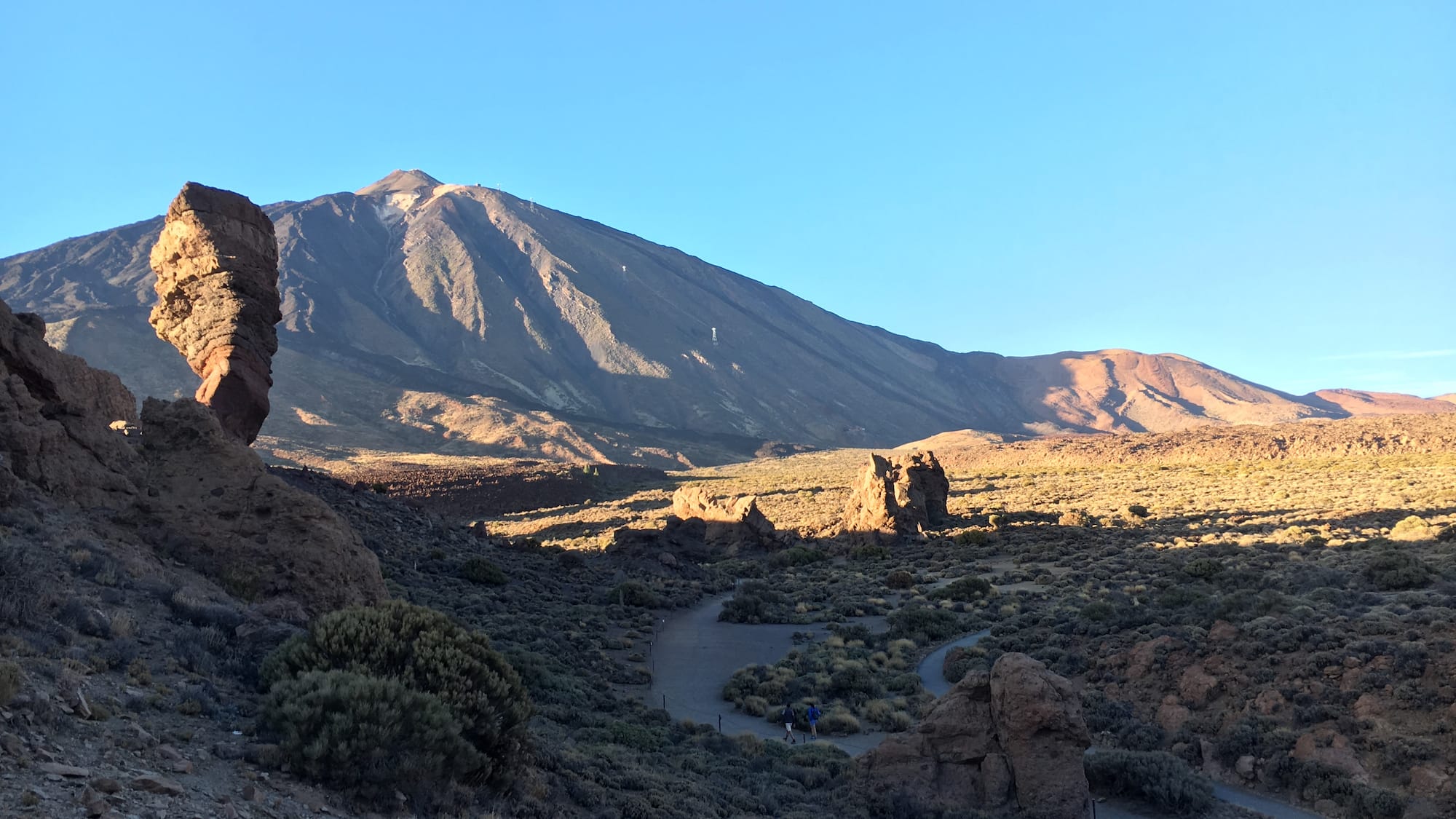 Teide volcano and Roques de García with hikers on a trail in Tenerife.