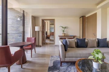 a living room with a couch and chairs