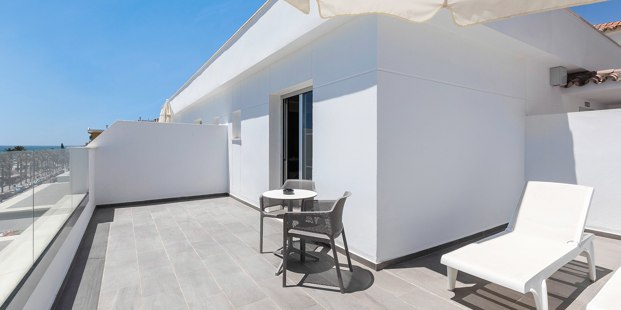 a patio with chairs and a table