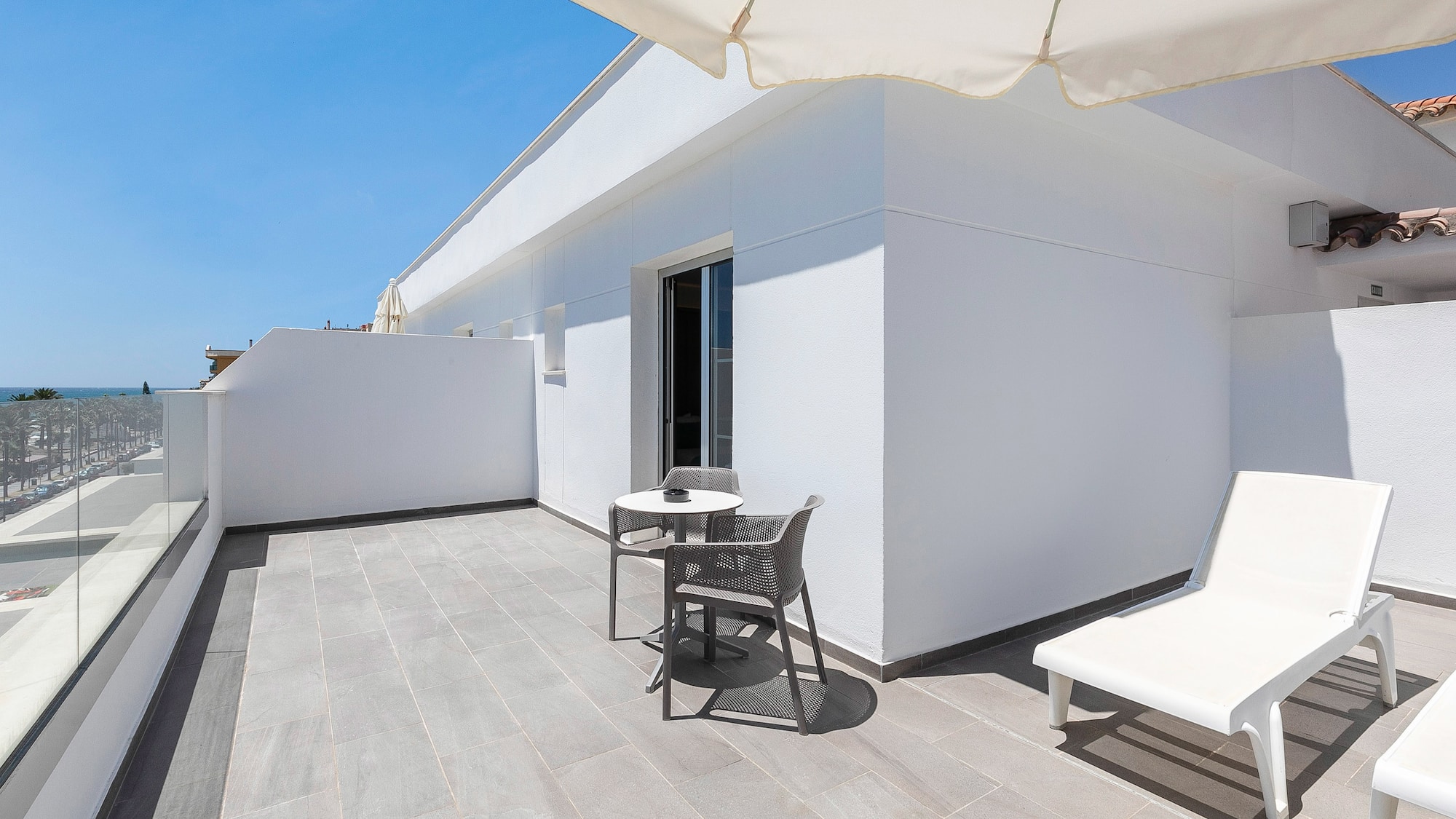 a patio with chairs and a table