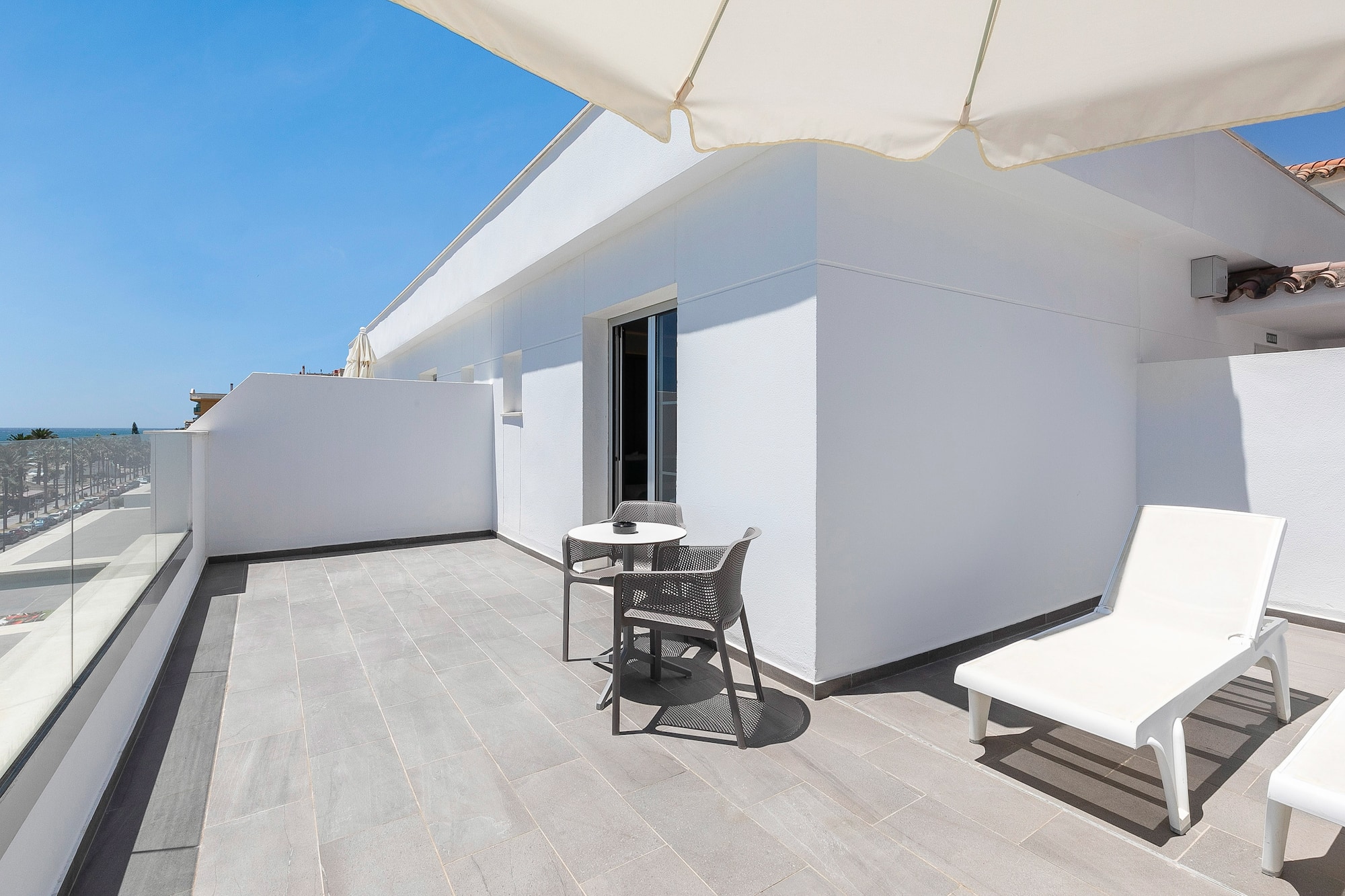 a patio with chairs and a table