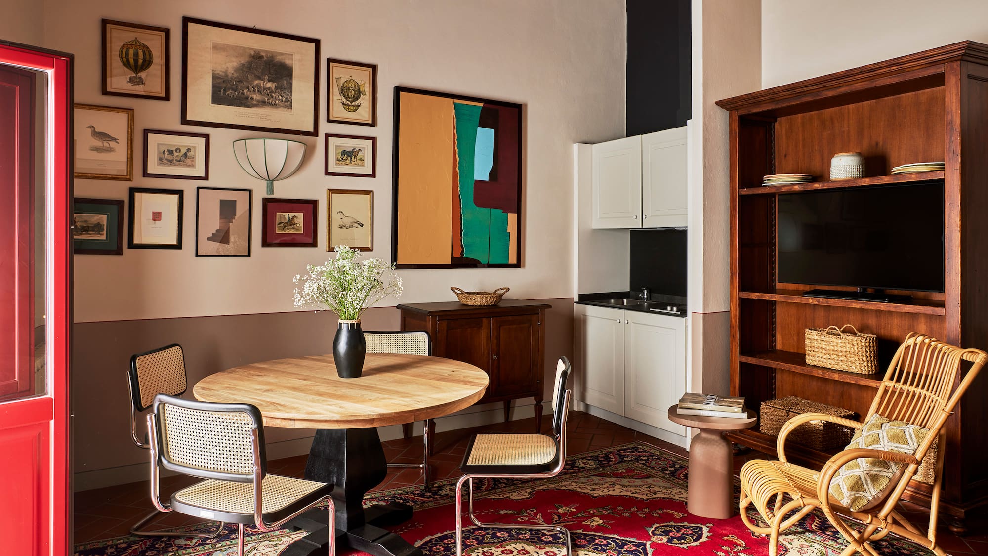 a room with a round table and chairs