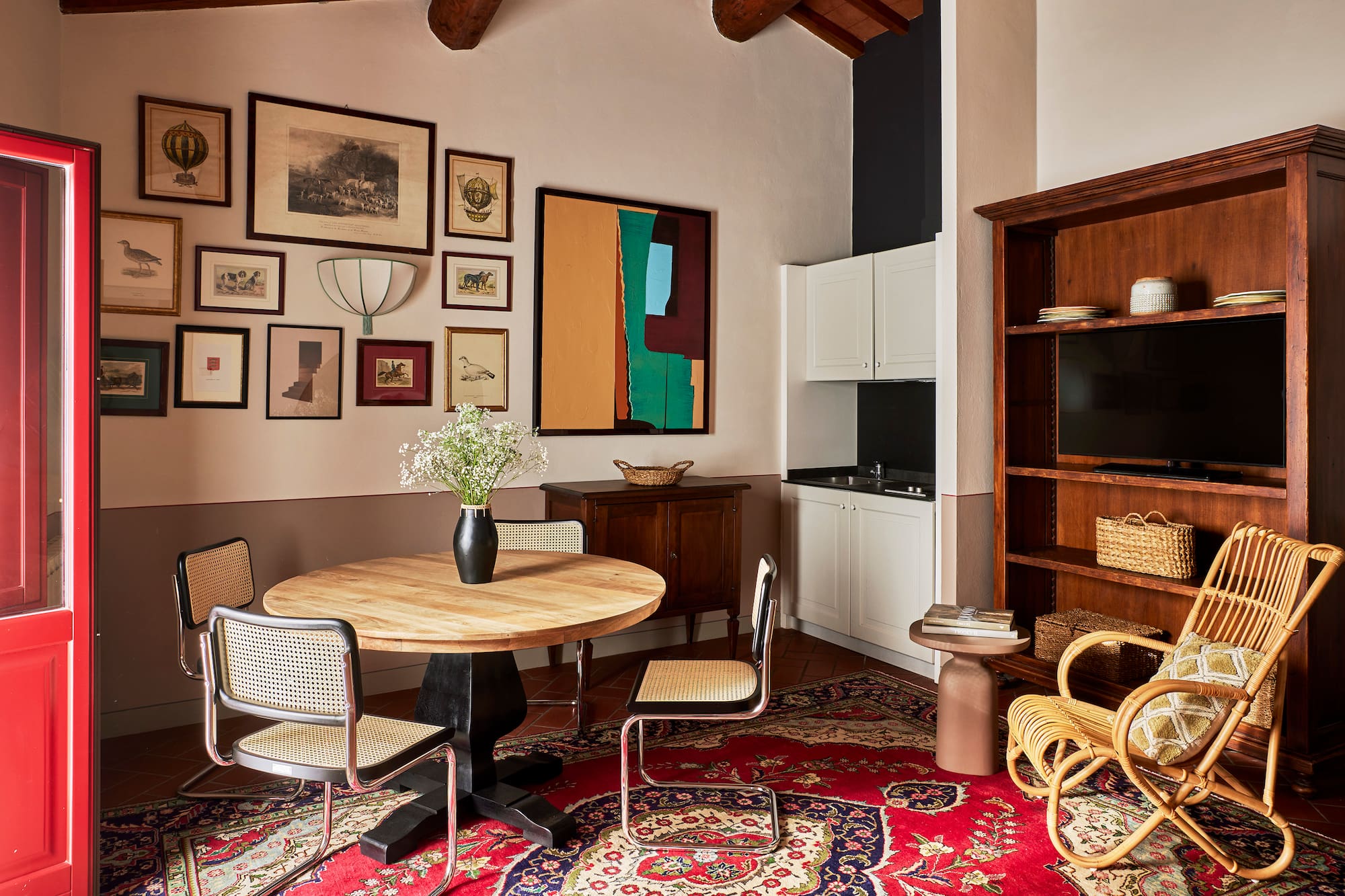 a room with a round table and chairs