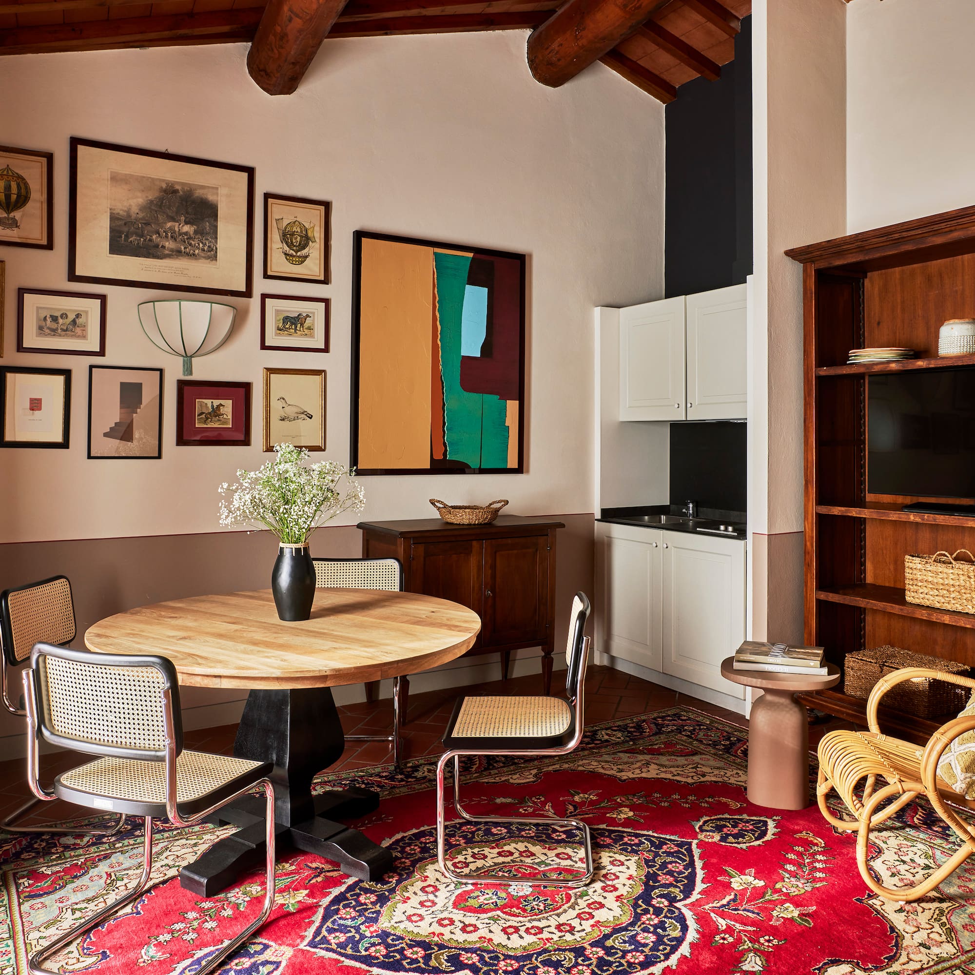 a room with a round table and chairs