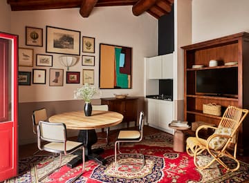 a room with a round table and chairs