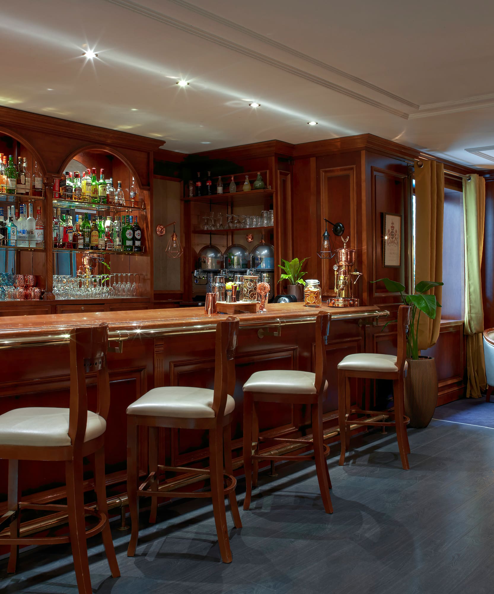 a bar with shelves and chairs
