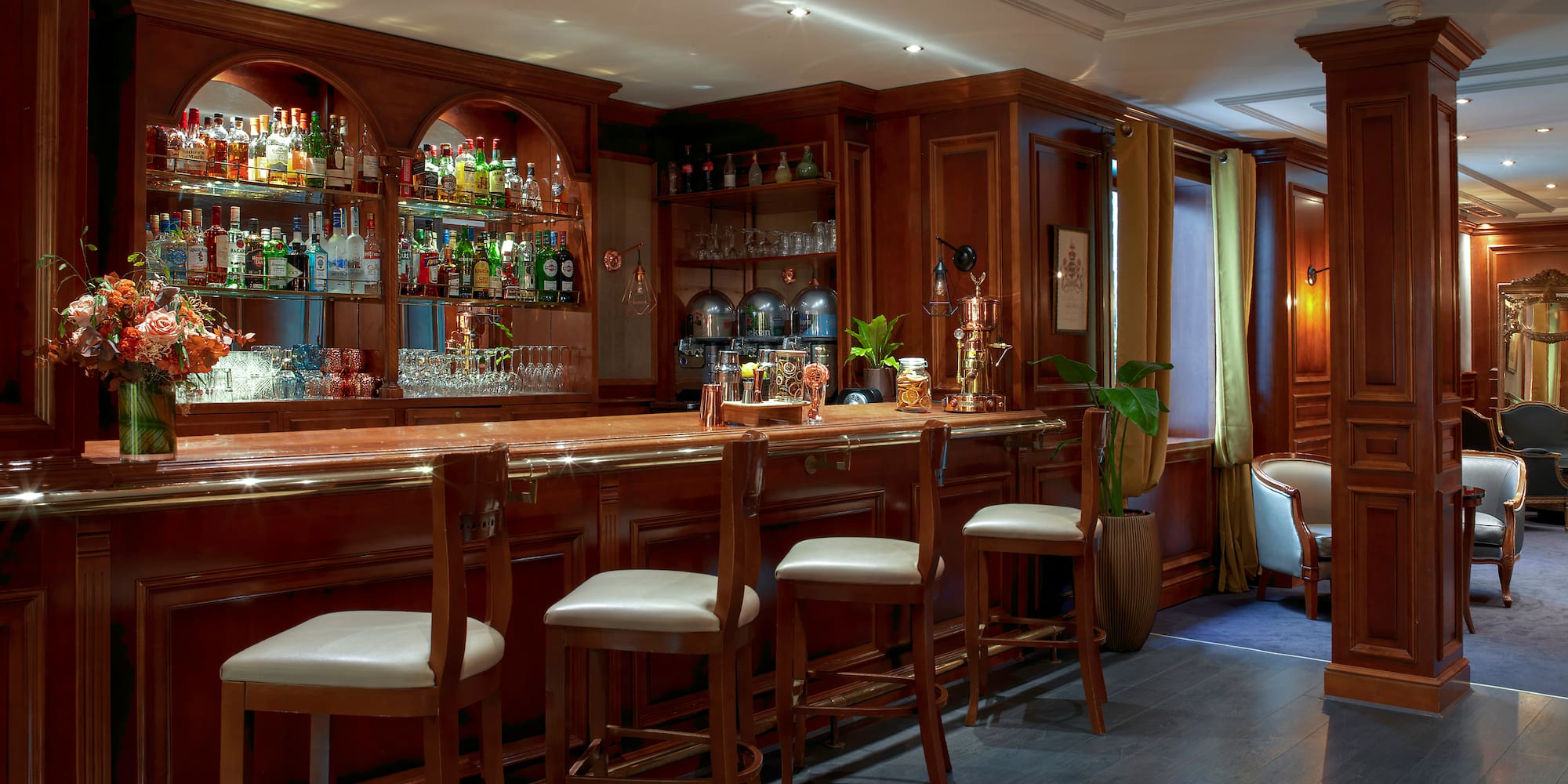 a bar with shelves and chairs