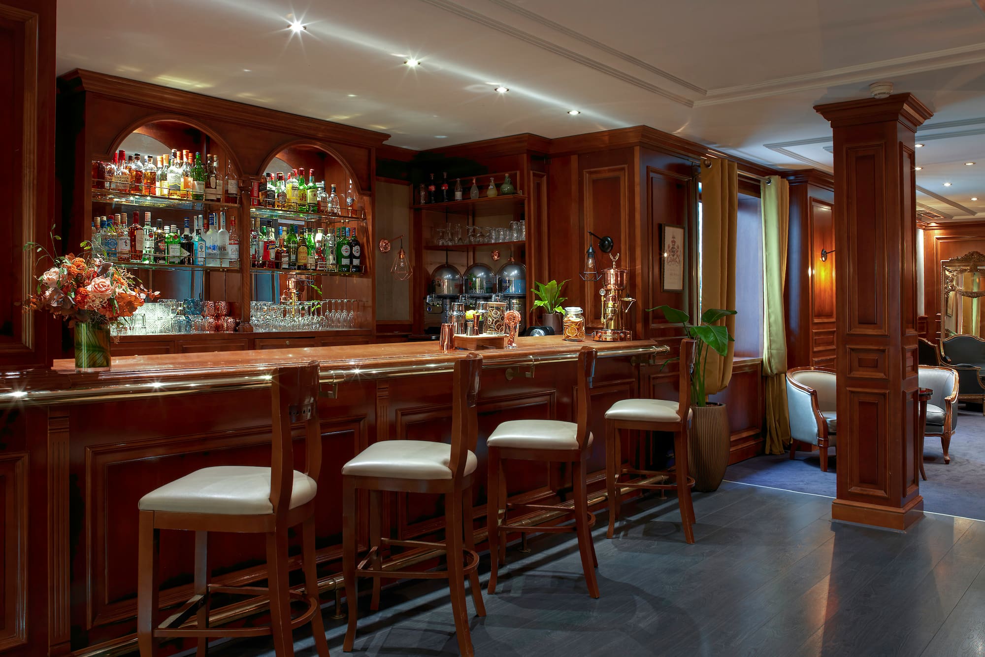 a bar with shelves and chairs
