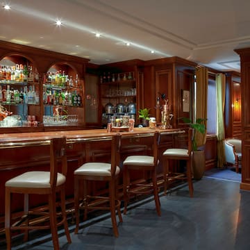 a bar with shelves and chairs