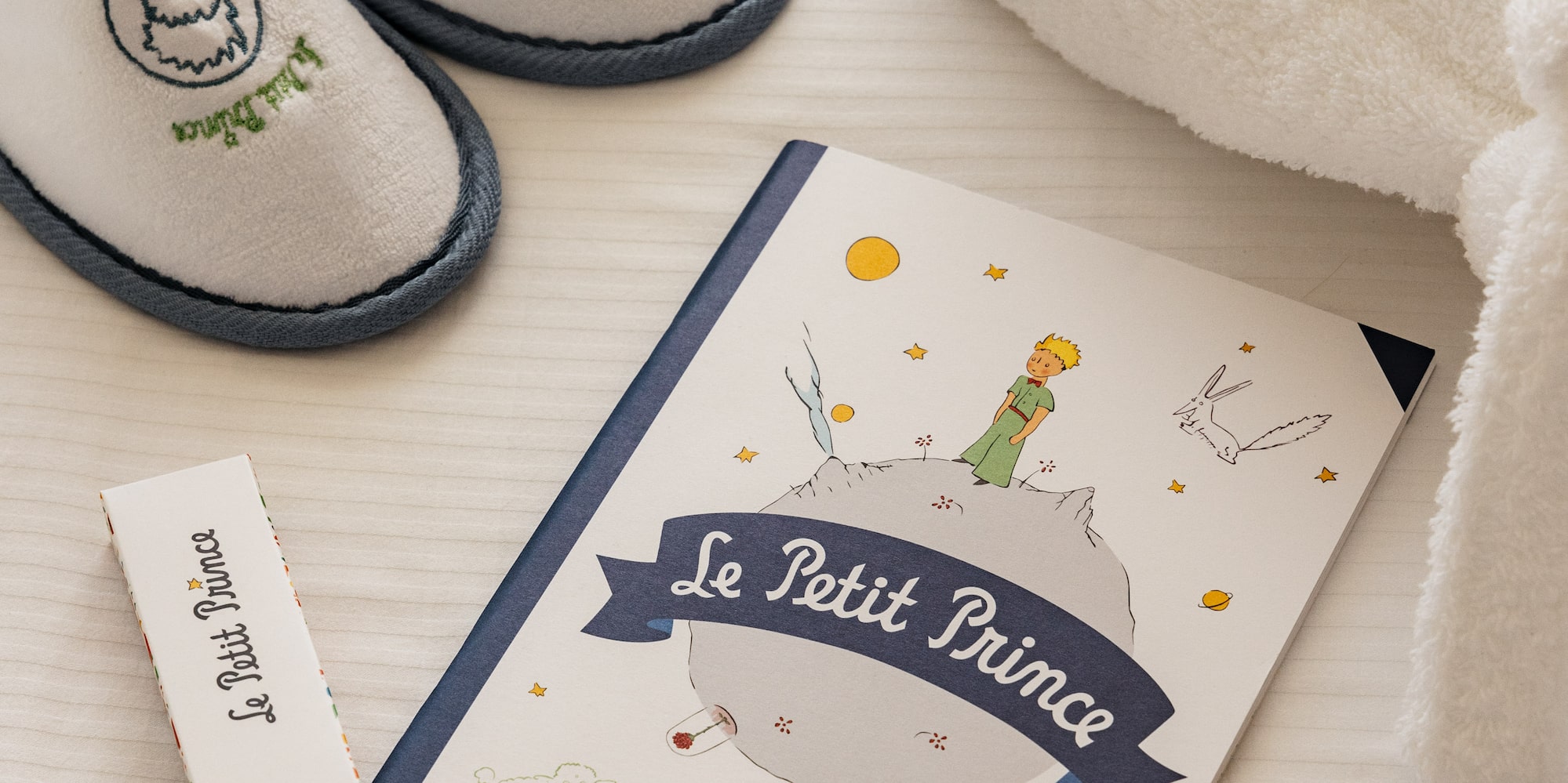 a book and slippers on a table