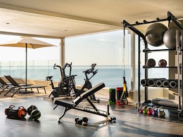 a room with exercise equipment and a large window