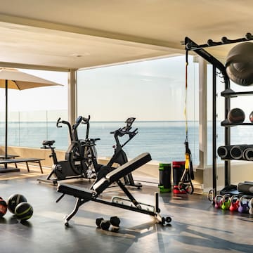 a room with exercise equipment and a large window