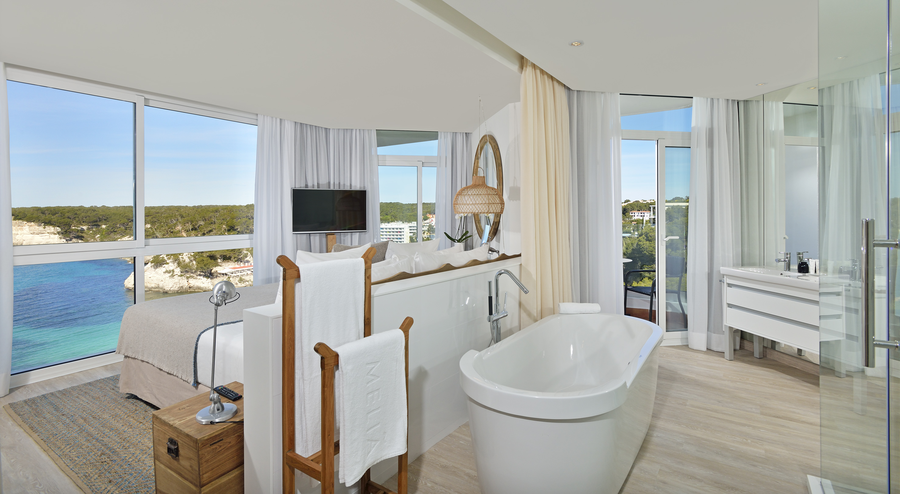 Meliá hotel suite with panoramic sea view, freestanding tub, and modern design.