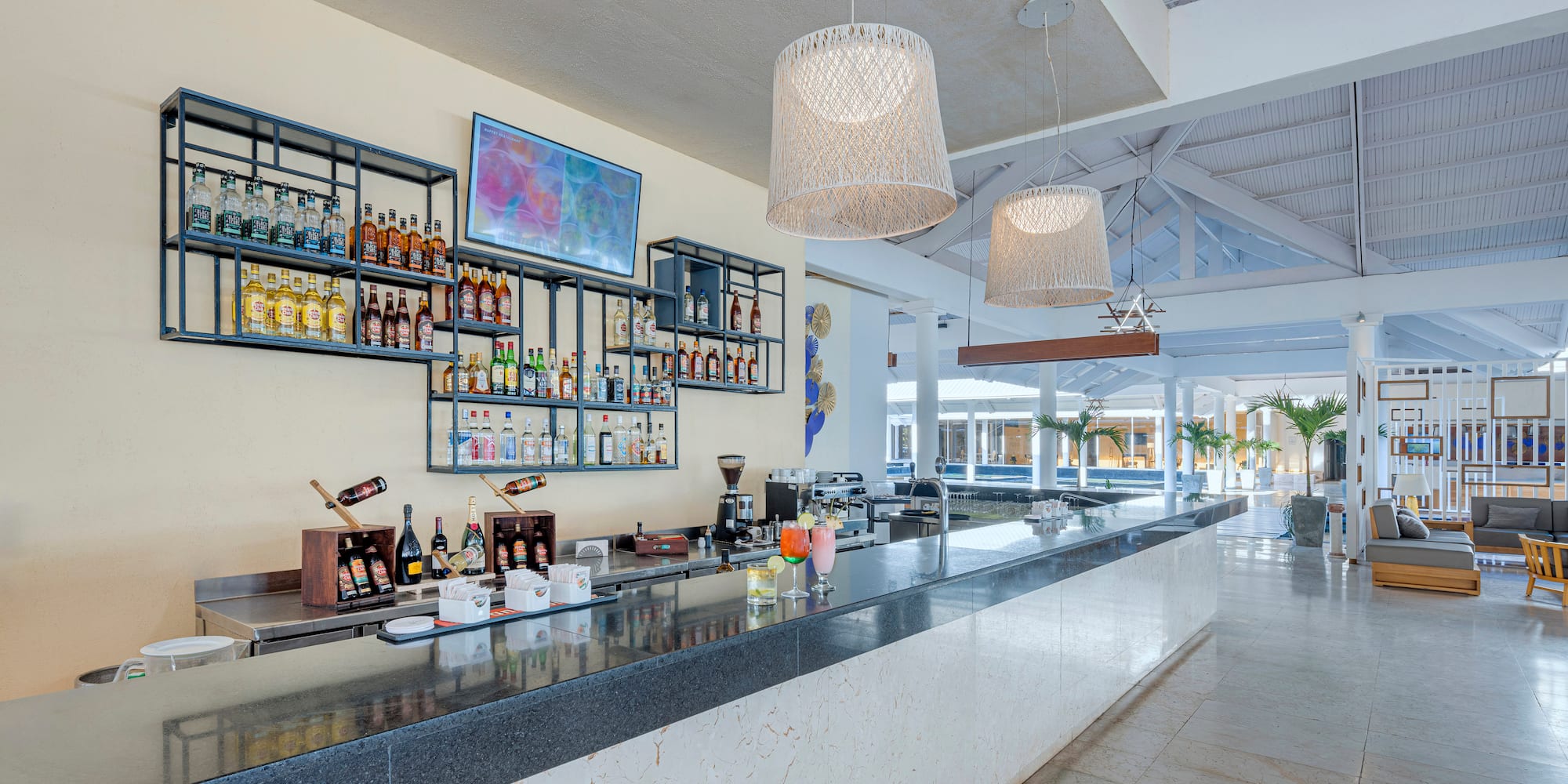 a bar with bottles of alcohol on the wall